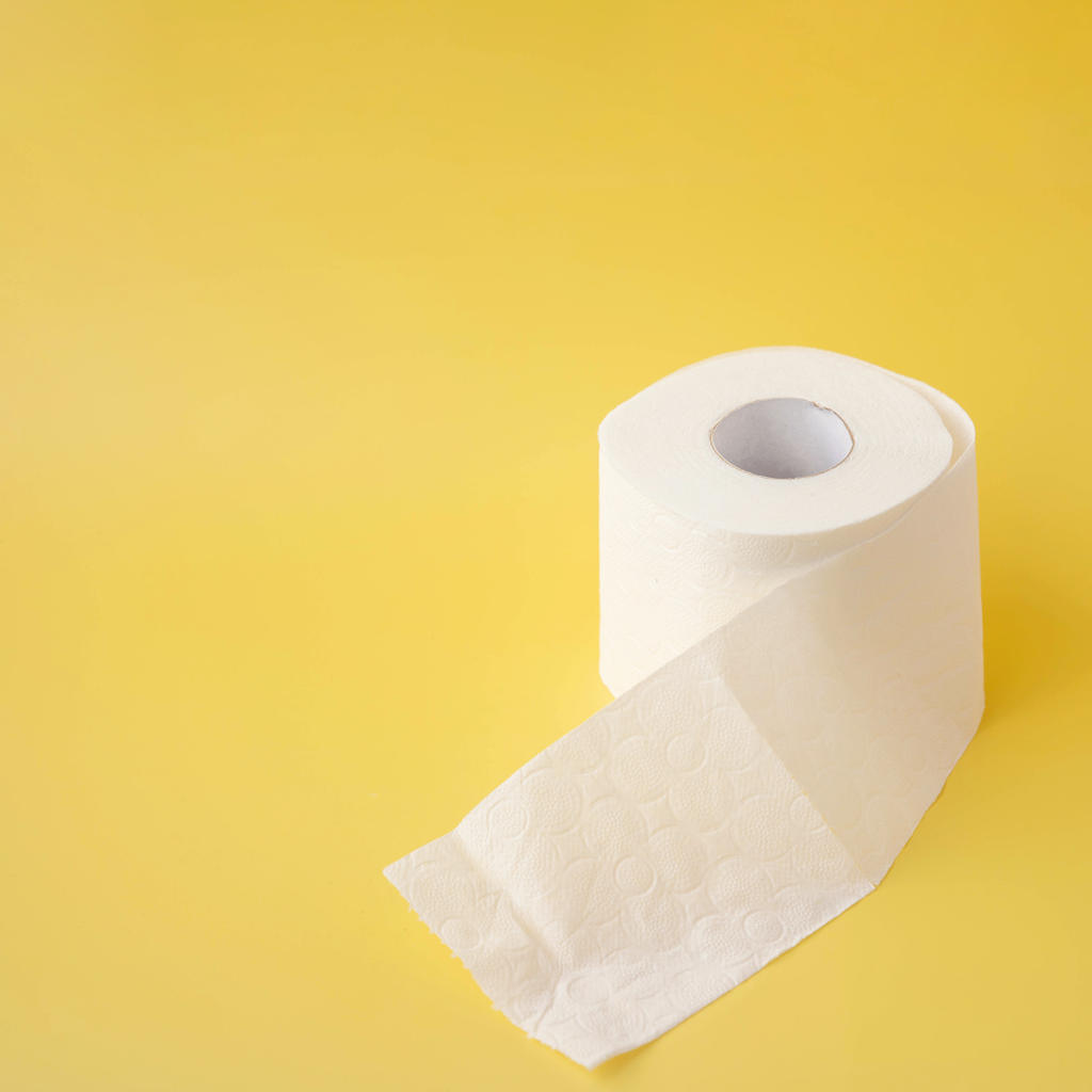 A roll of toilet paper on a yellow background.